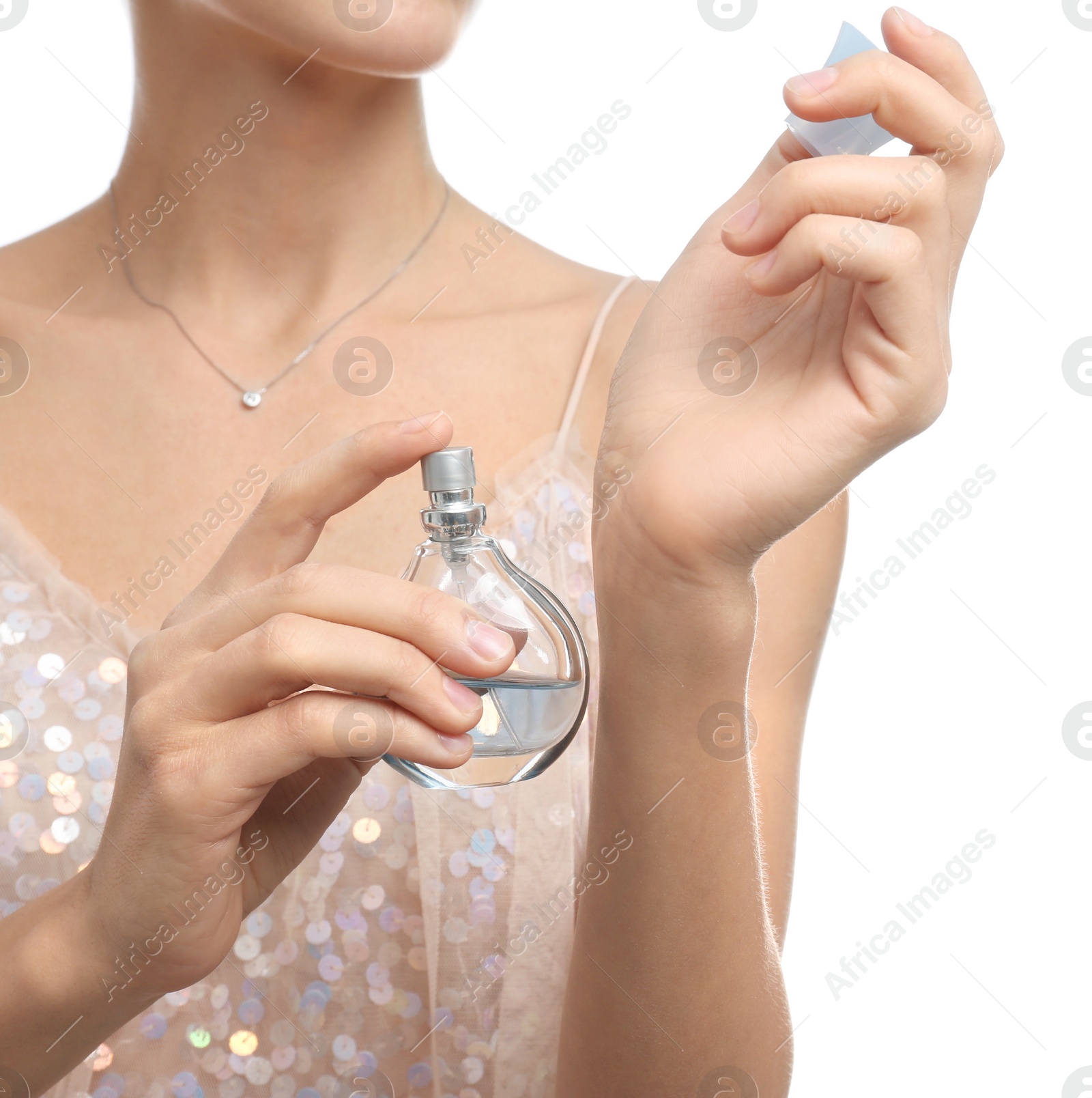 Photo of Young woman spraying perfume onto skin against white background, closeup