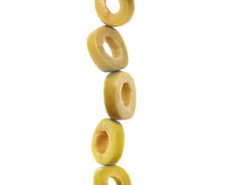 Stacked slices of green olive on white background