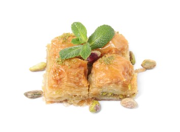 Photo of Delicious baklava with pistachios, mint and scattered nuts on white background