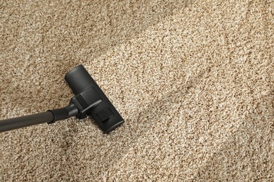 Image of Hoovering carpet with vacuum cleaner, above view and space for text. Clean trace on dirty surface