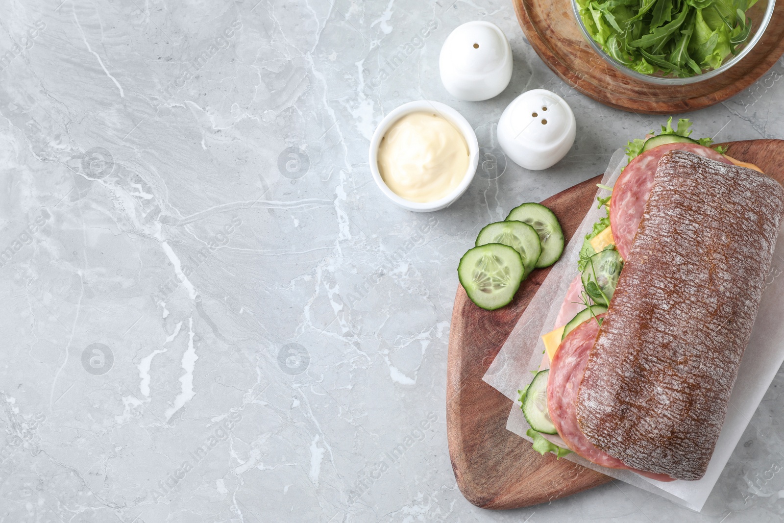 Photo of Tasty sandwich with ham on grey table, flat lay. Space for text