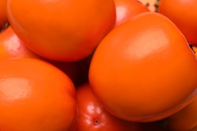 Photo of Delicious ripe juicy persimmons as background, closeup