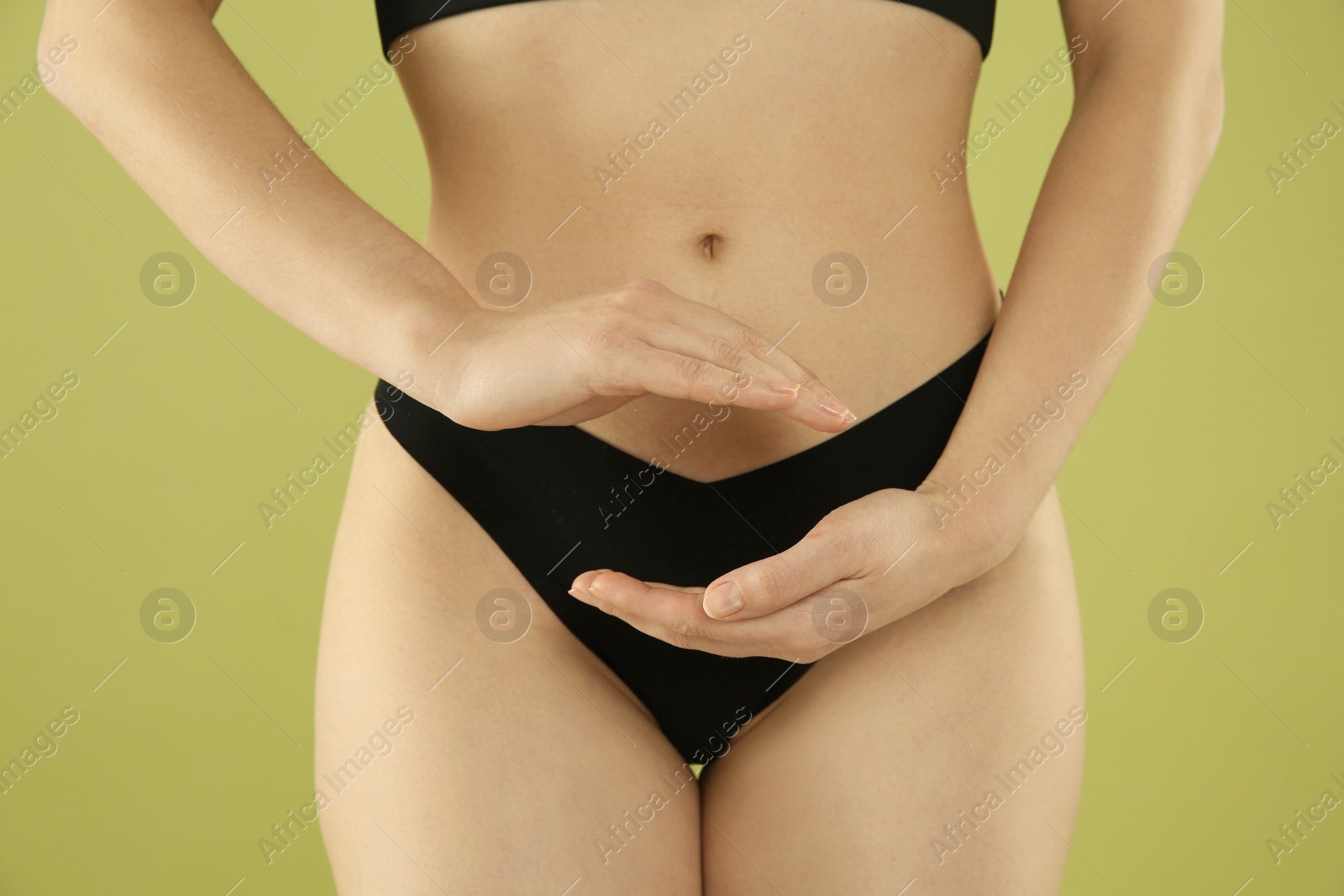 Photo of Gynecology. Woman in underwear on green background, closeup