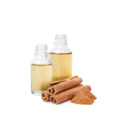 Image of Bottles of natural essential oil, dry cinnamon sticks and powder on white background