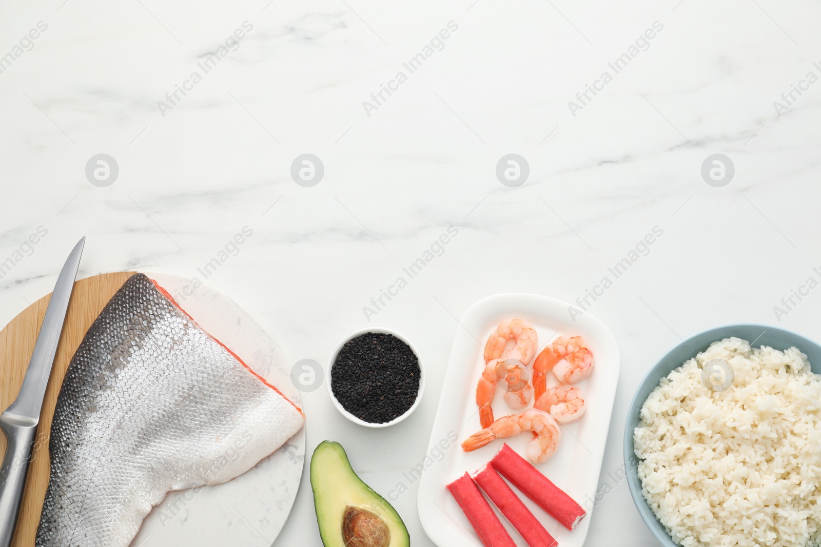 Photo of Making sushi rolls. Flat lay composition with ingredients on white marble table. Space for text