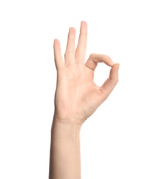 Photo of Young woman showing OK gesture on white background