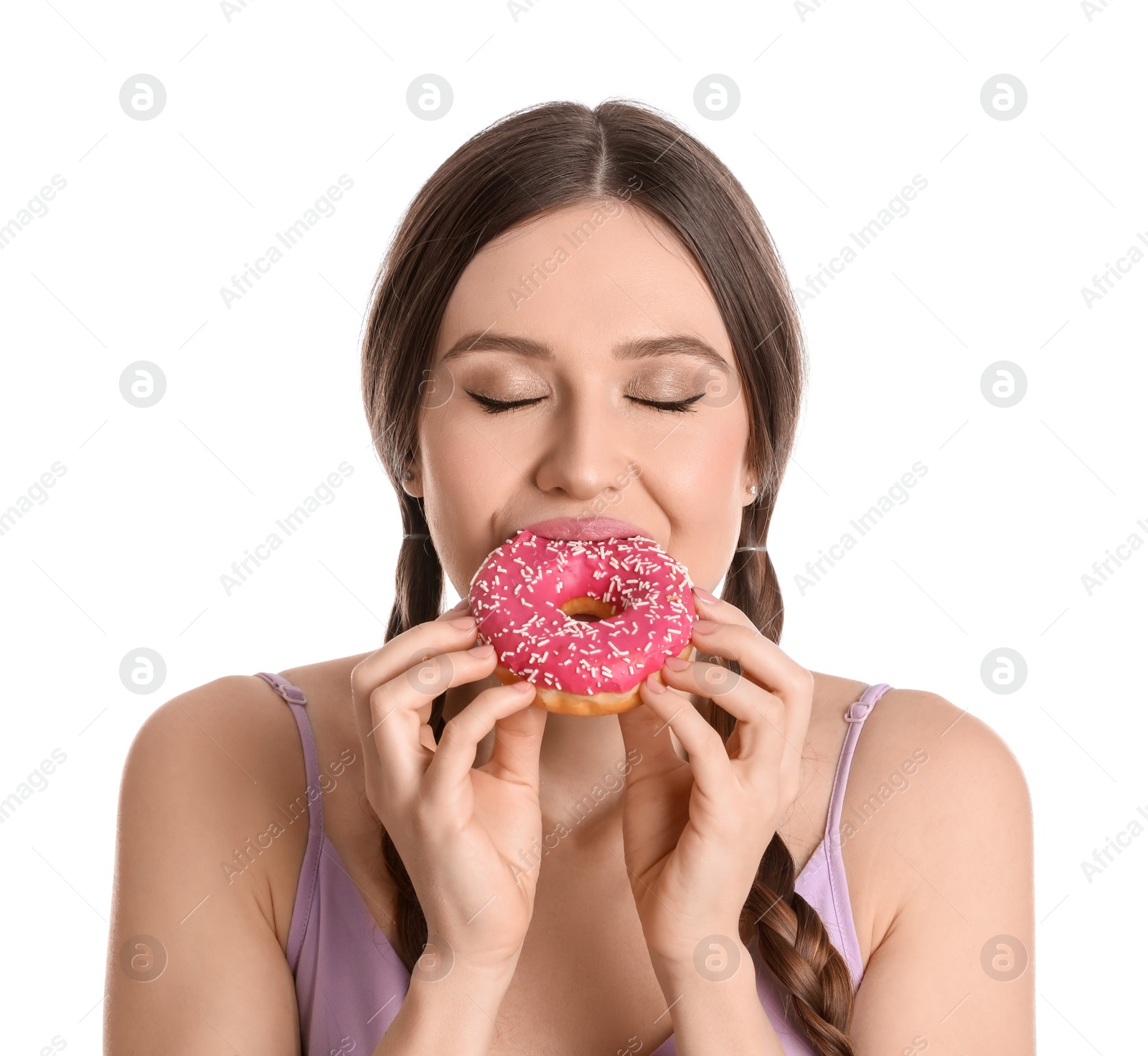 Photo of Beautiful young woman eating donut on white background