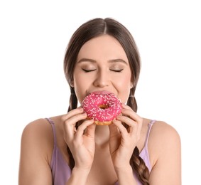 Beautiful young woman eating donut on white background
