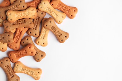 Bone shaped dog cookies on white background, top view. Space for text