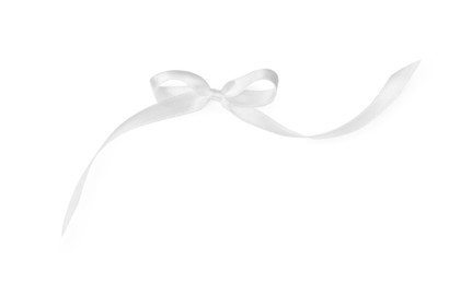 Photo of Satin ribbon tied in bow on white background, top view