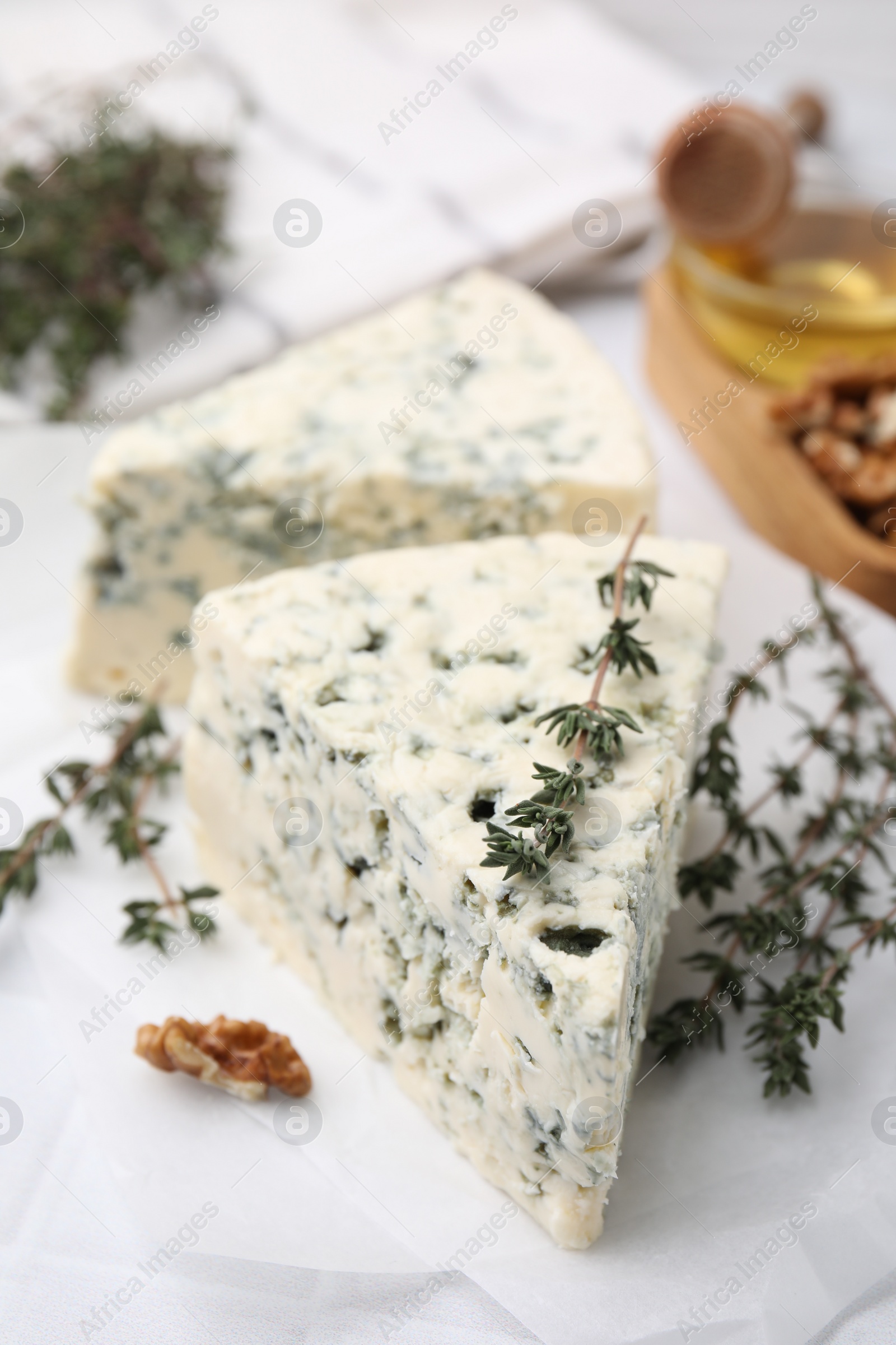 Photo of Tasty blue cheese with thyme on white table