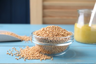 Photo of Mustard seeds in glass bowl on turquoise wooden table