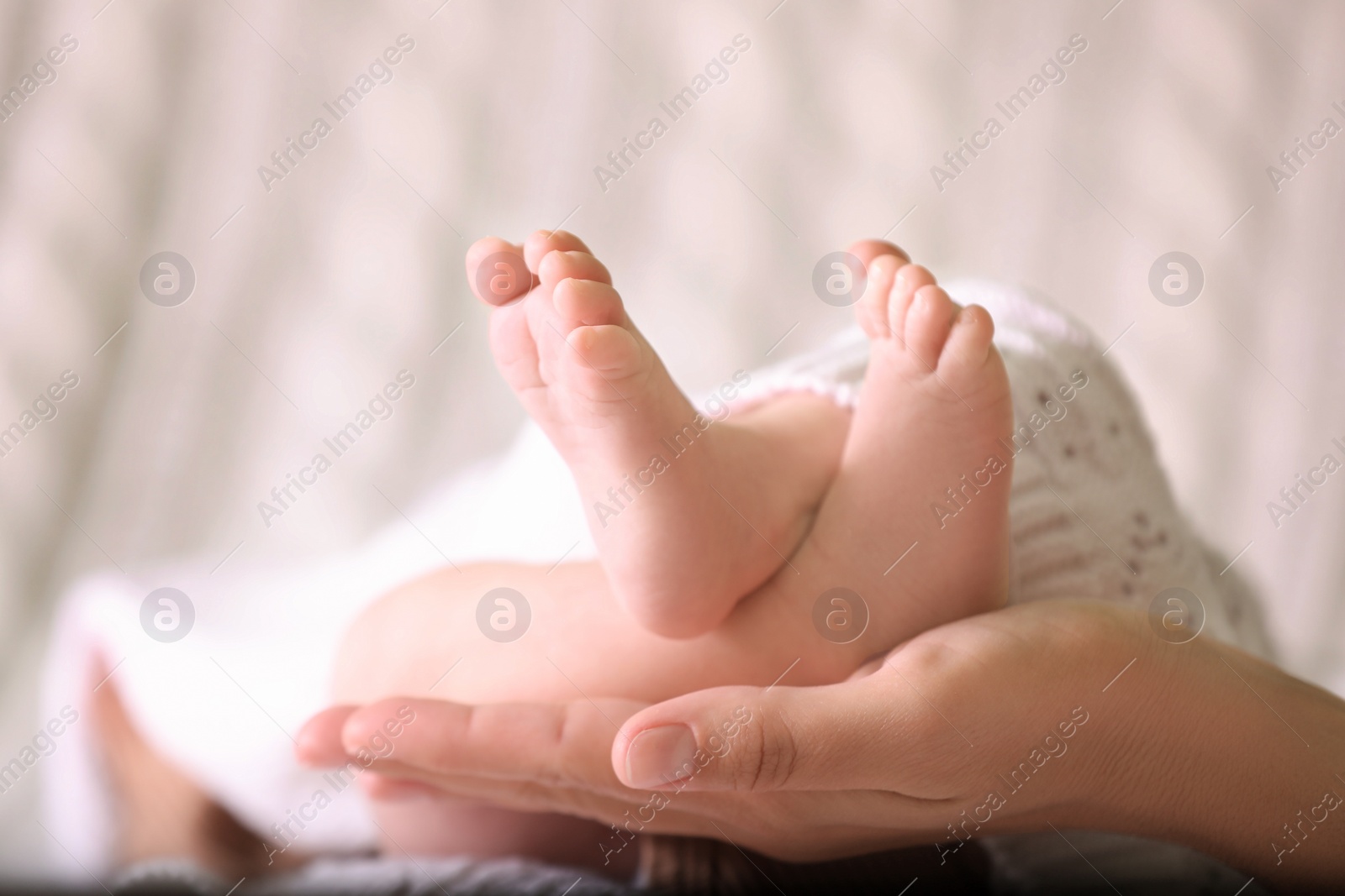 Photo of Mother and her newborn baby on bed, closeup. Space for text