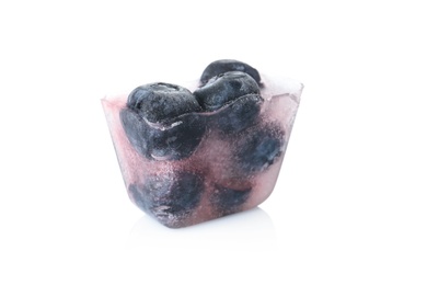 Photo of Ice cube with blueberries on white background