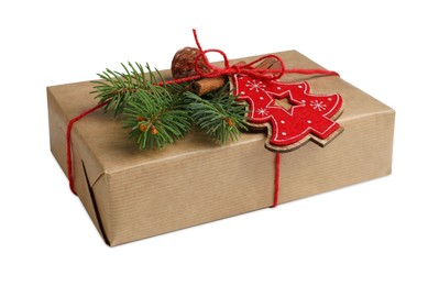 Photo of Christmas gift. Decorated box wrapped in kraft paper on white background