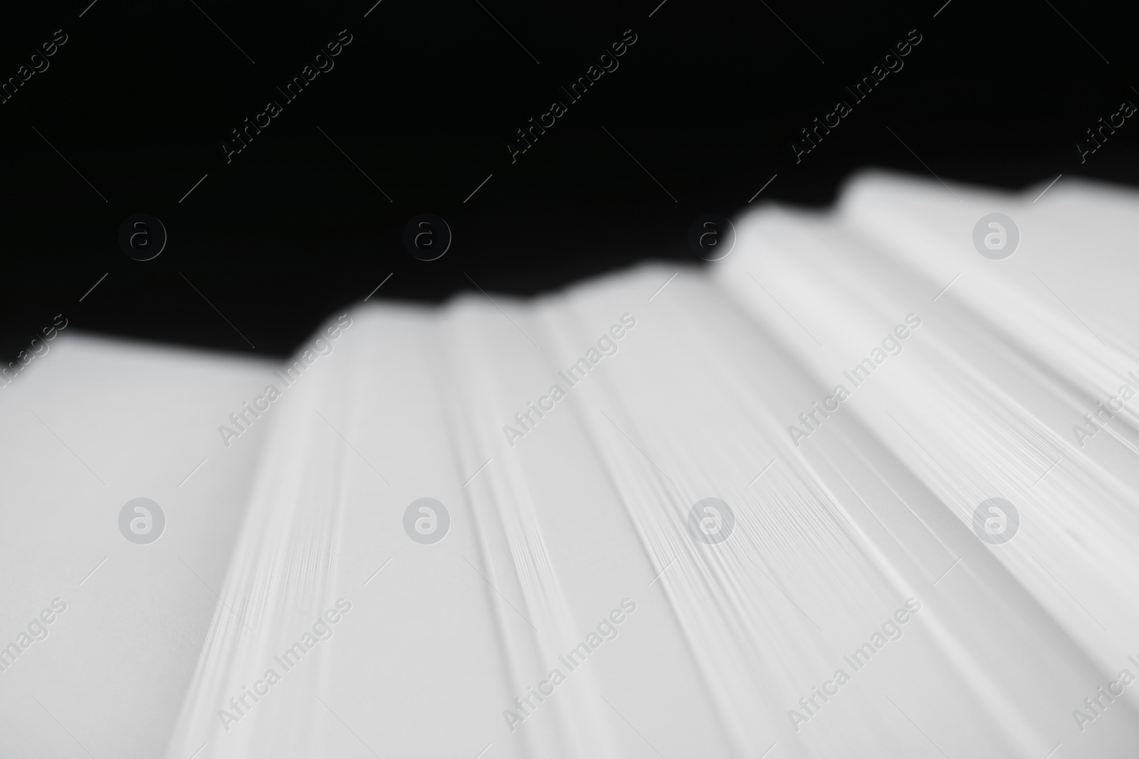 Photo of Stack of blank paper on dark background, closeup