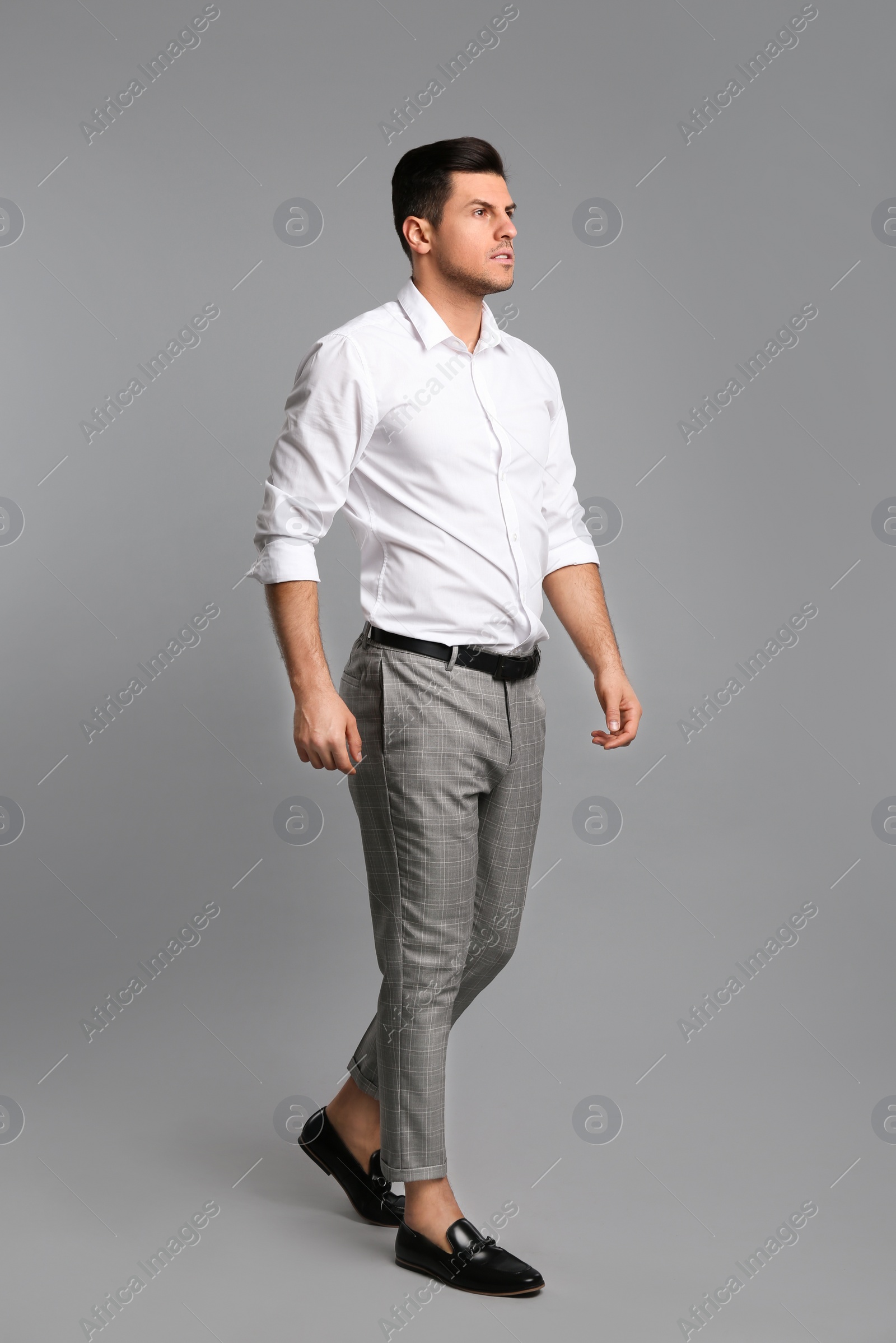 Photo of Businessman in formal clothes on grey background
