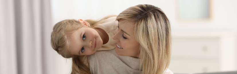 Image of Mother and her little daughter spending time together at home, banner design