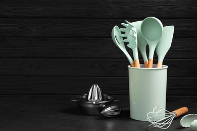 Photo of Set of different kitchen utensils on grey table, space for text