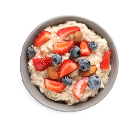 Photo of Tasty oatmeal porridge with blueberries, strawberries and almond nuts in bowl on white background, top view