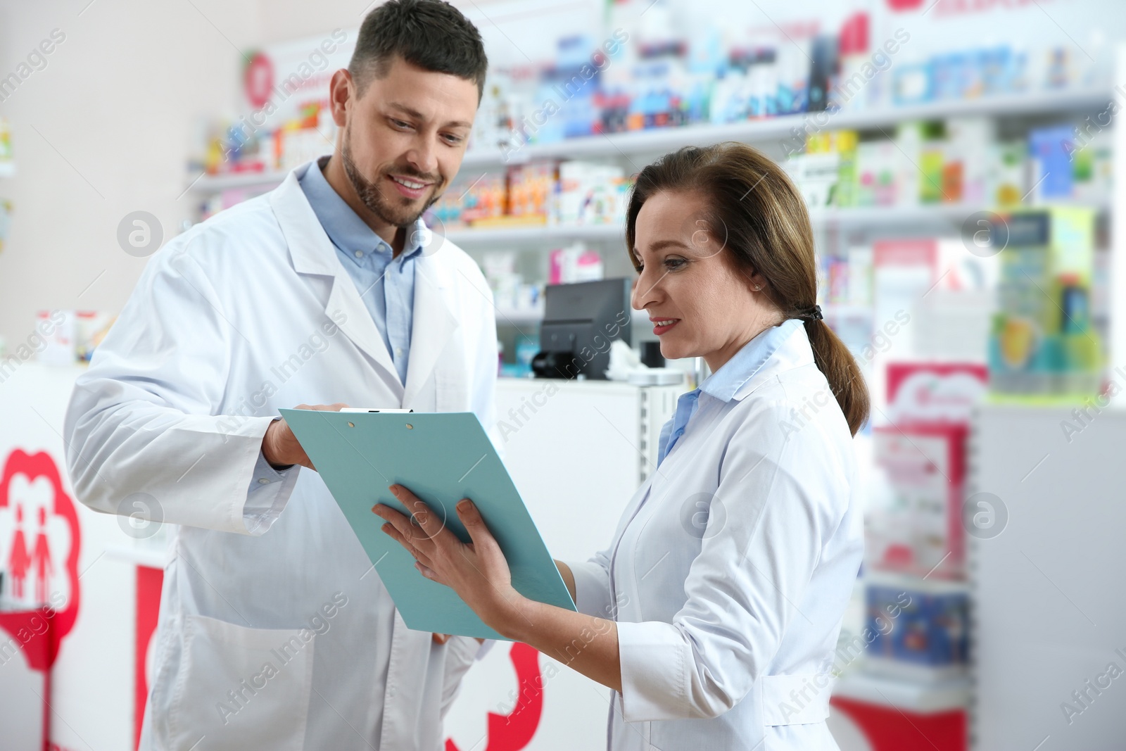 Photo of Portrait of professional pharmacists in modern drugstore