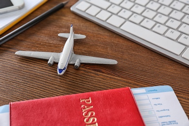 Photo of Composition with airplane model on wooden table. Travel agency concept