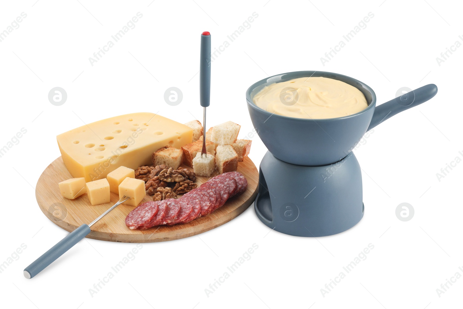 Photo of Fondue with tasty melted cheese, forks and different snacks isolated on white