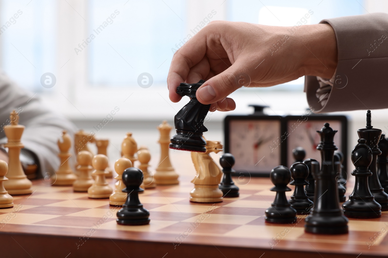 Photo of Man playing chess during tournament at chessboard, closeup