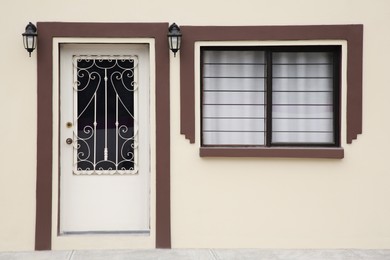 Photo of Entrance of residential house with white door and window