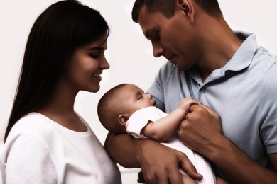 Image of Happy family with their cute baby on white background