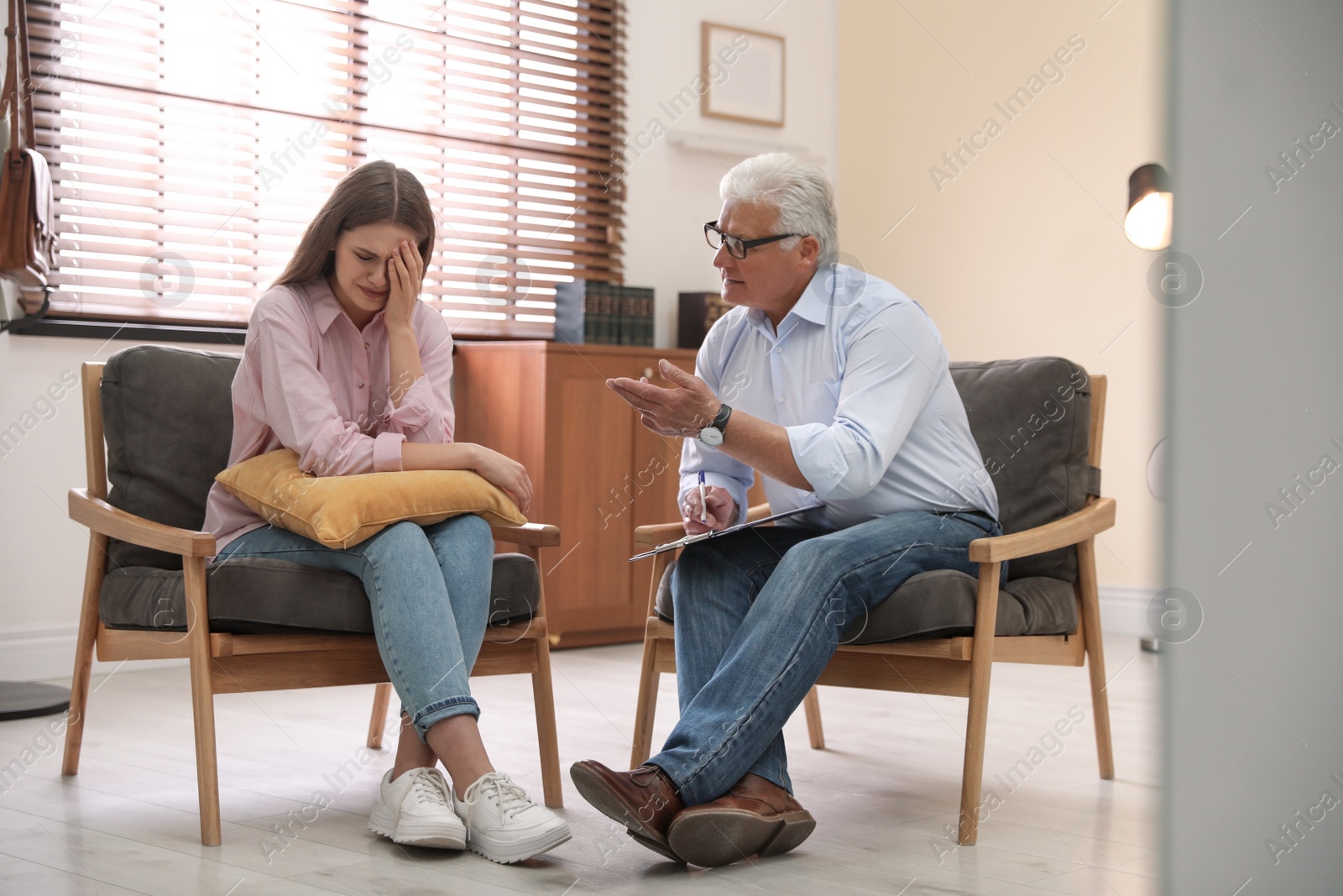 Photo of Professional psychotherapist working with patient in office