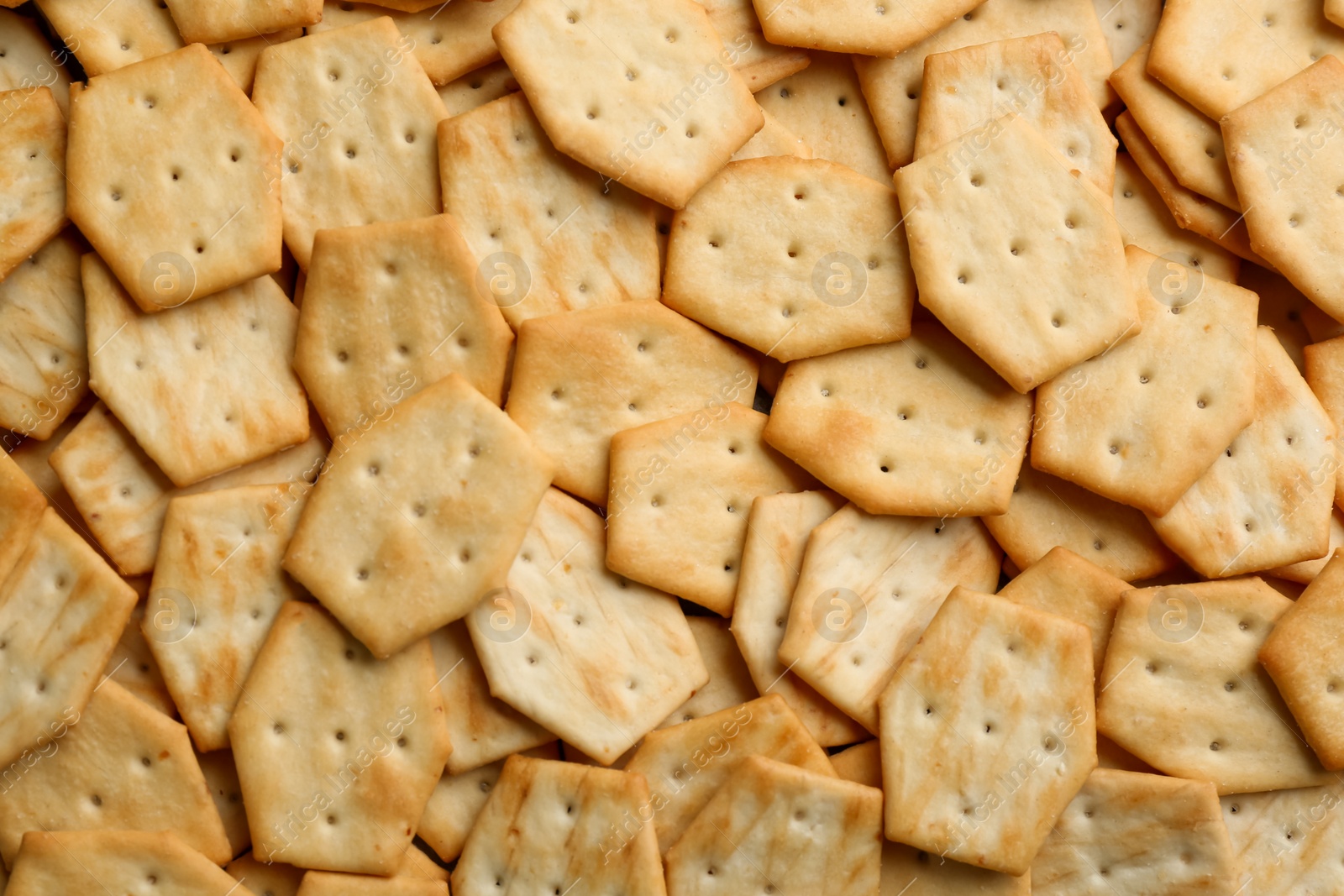 Photo of Many delicious crackers as background, top view