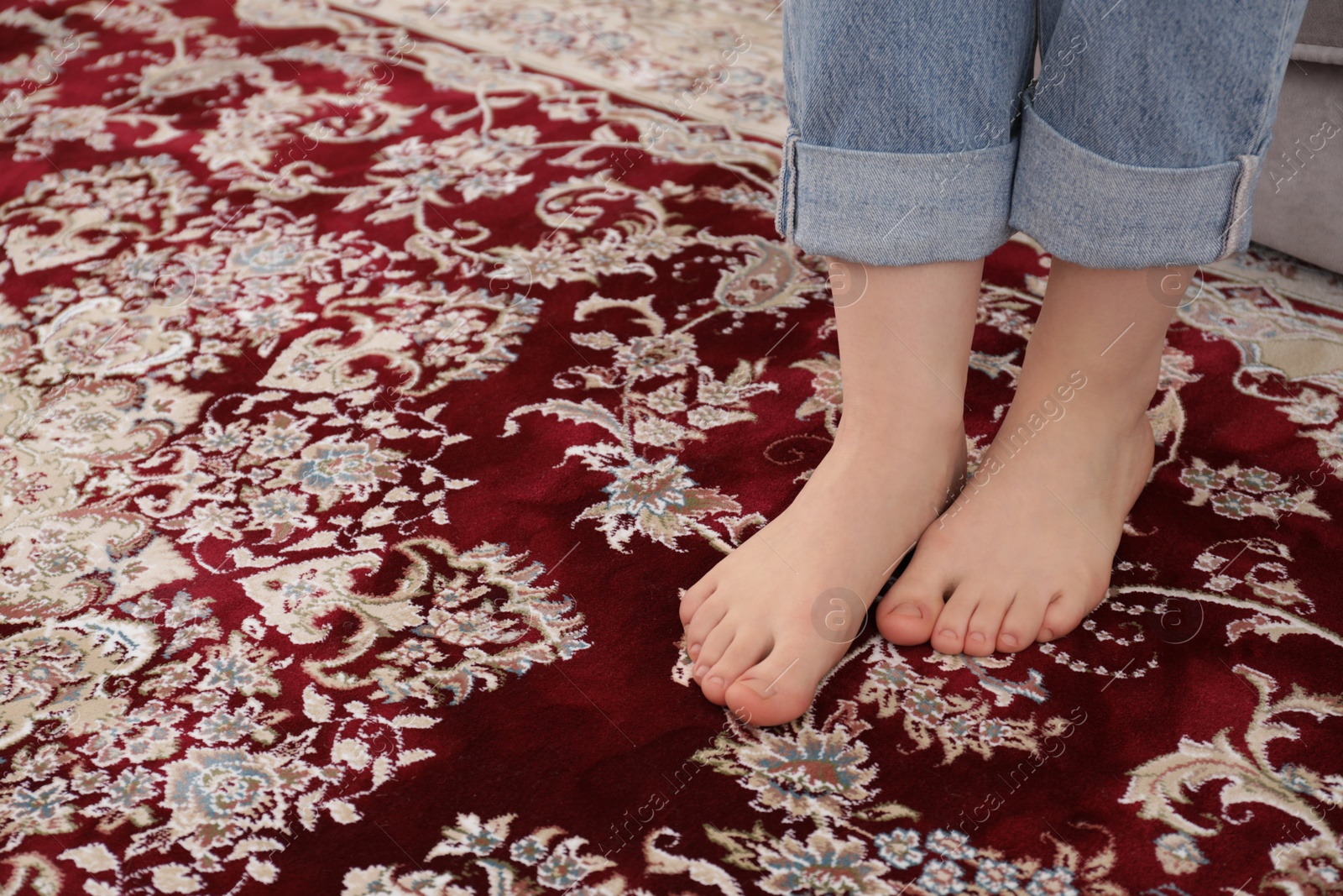 Photo of Woman sitting on sofa at home, closeup. Space for text