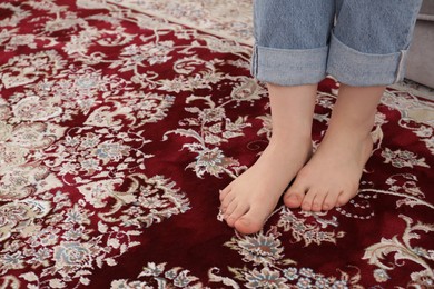 Woman sitting on sofa at home, closeup. Space for text