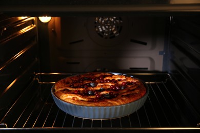 Delicious homemade currant pie in oven, closeup
