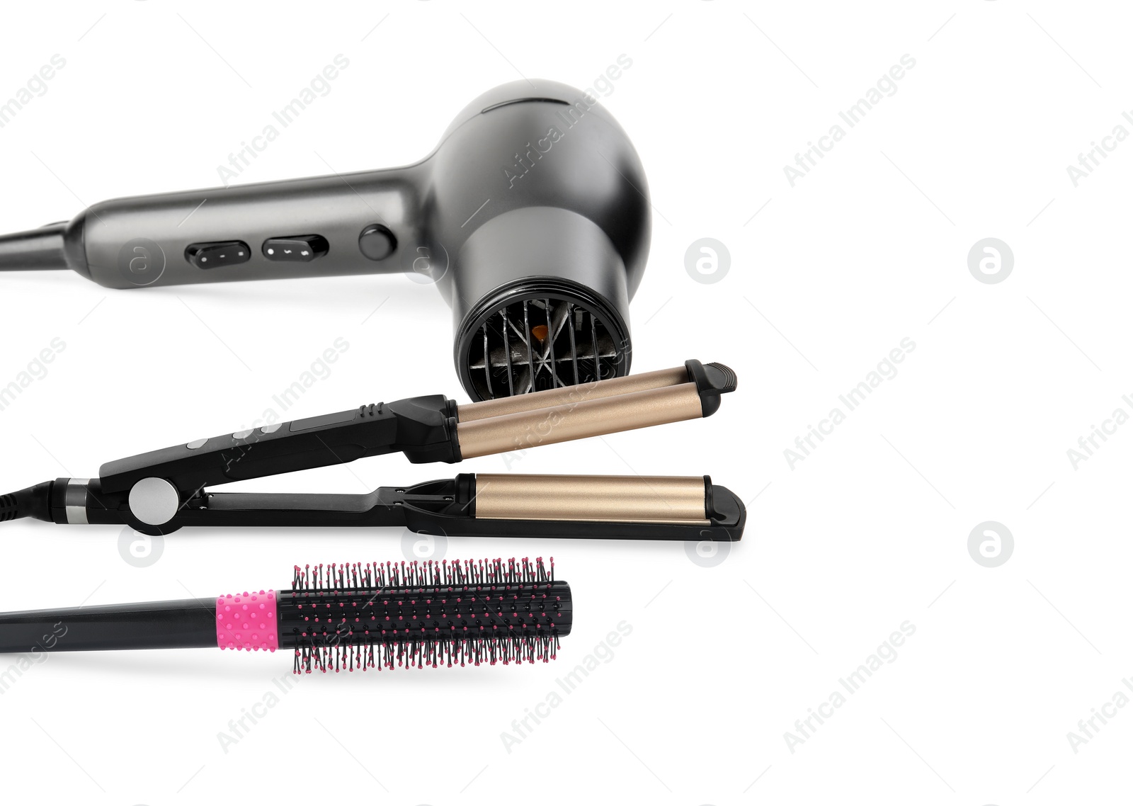 Image of Hair dryer, triple curling iron and round brush on white background