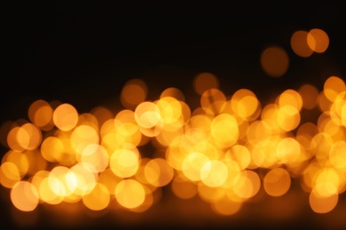 Gold glitter with bokeh effect on dark background