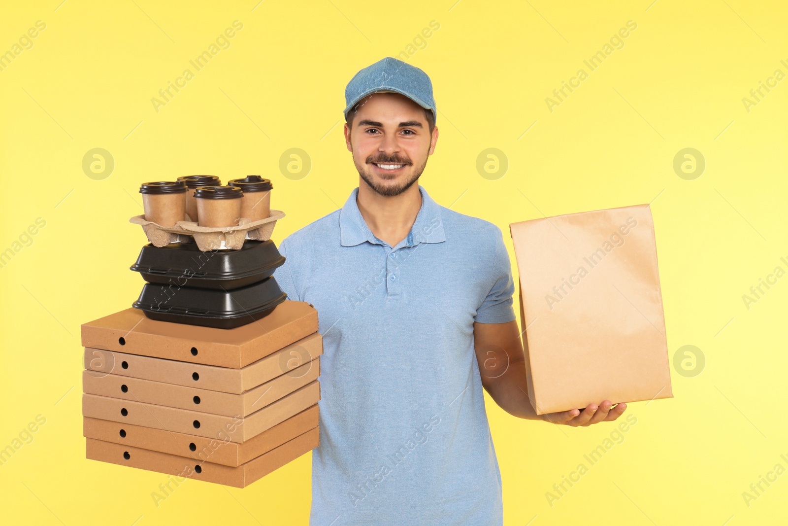 Photo of Young courier with different orders on color background. Food delivery service