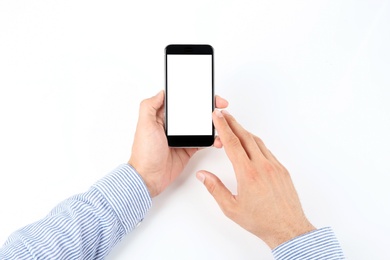 Photo of Young man holding mobile phone with blank screen in hand on white background