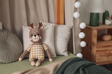 Photo of Toy deer on bed in child's room