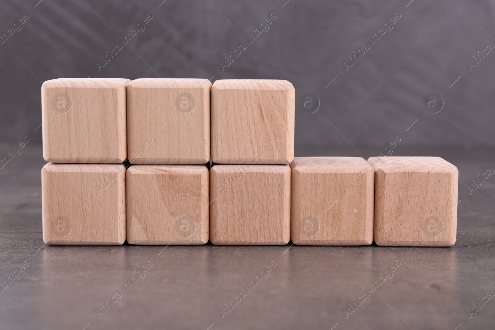 Photo of Wooden cubes with abbreviation ISO and number 18001 on grey textured table
