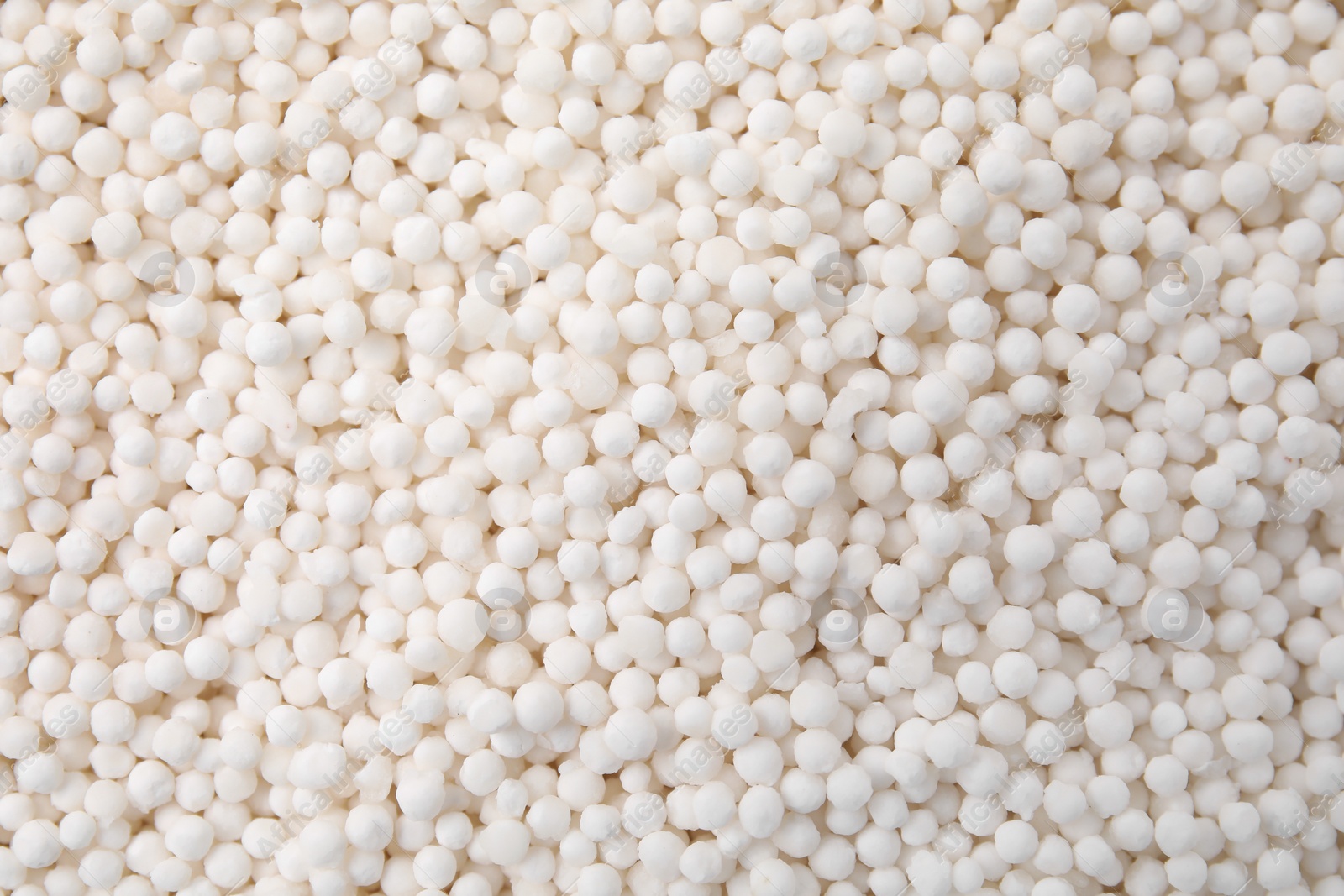 Photo of White tapioca pearls as background, top view