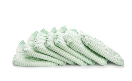 Photo of Pile of disposable diapers on white background. Baby accessories