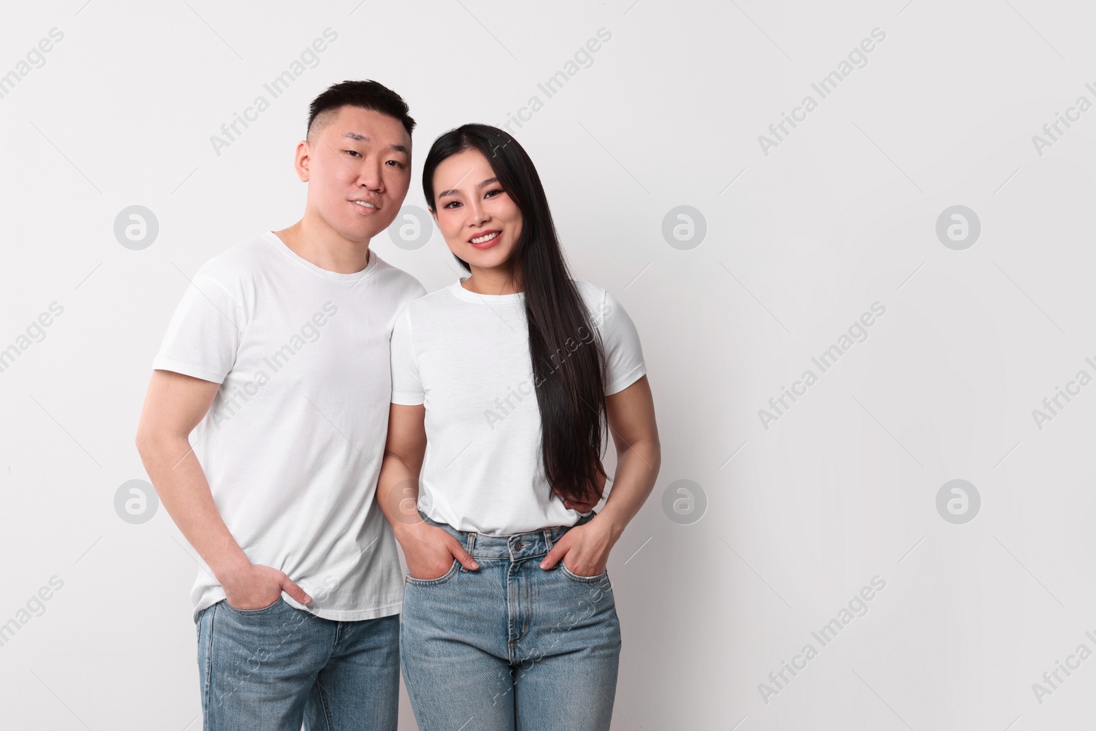 Photo of Portrait of happy couple on white background, space for text