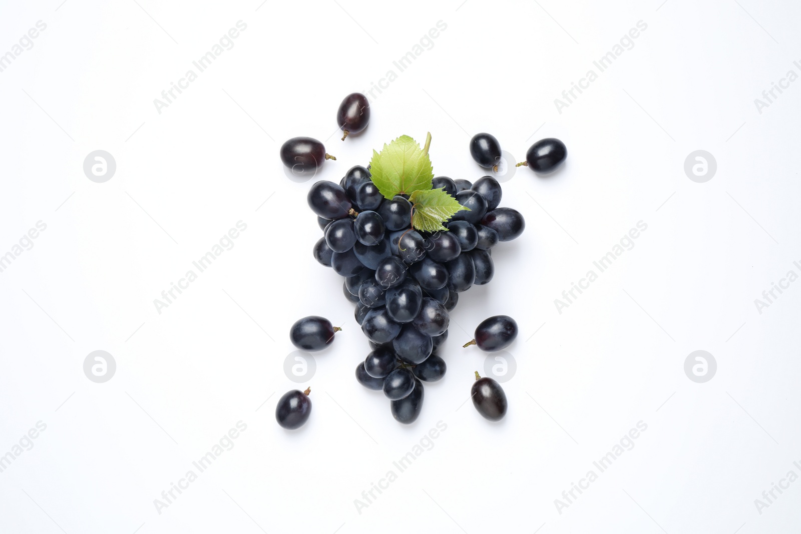 Photo of Bunch of dark blue grapes with green leaves on white background, top view