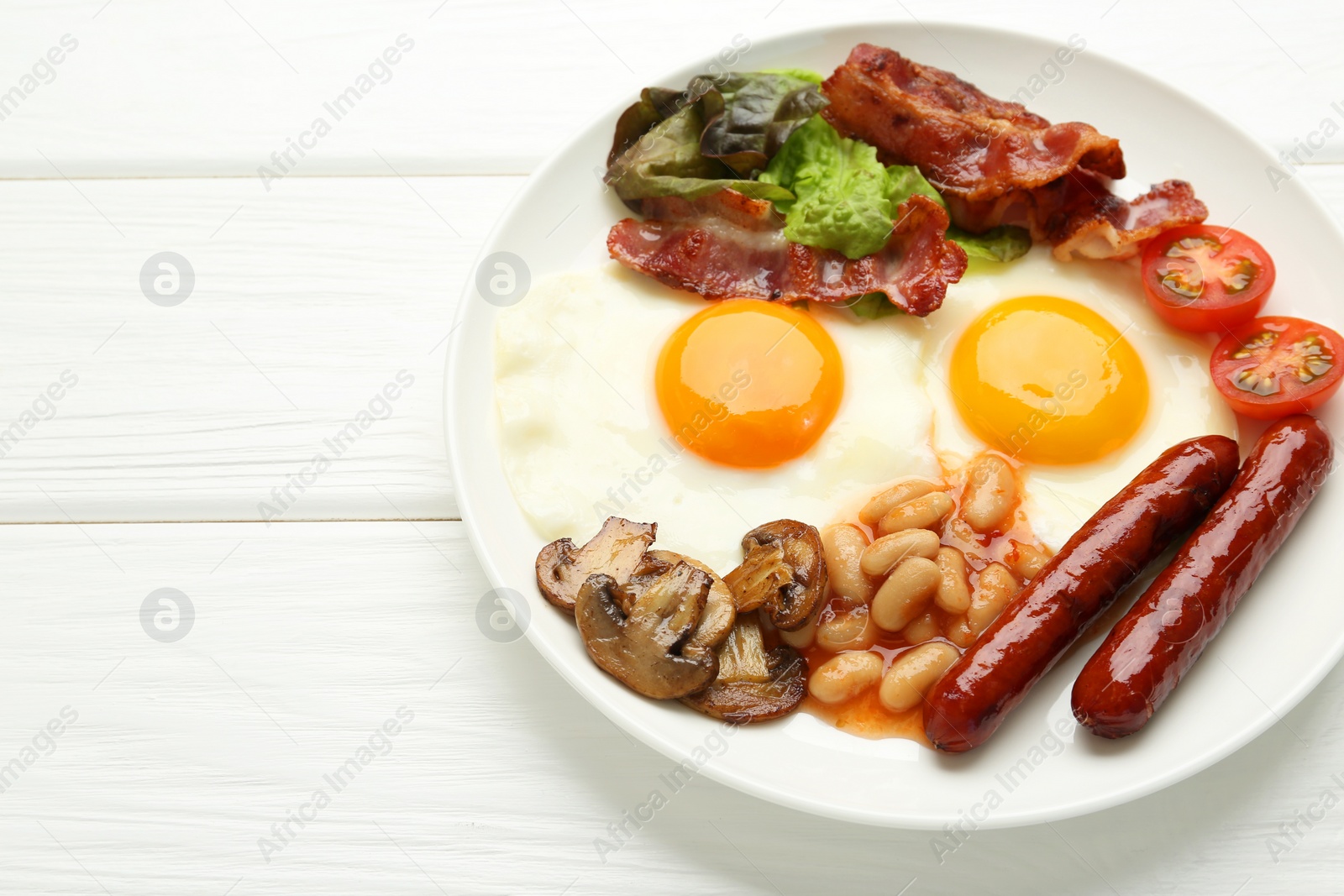 Photo of Delicious breakfast with sunny side up eggs on white wooden table, closeup