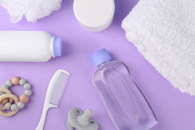 Photo of Flat lay composition with baby care products and accessories on violet background