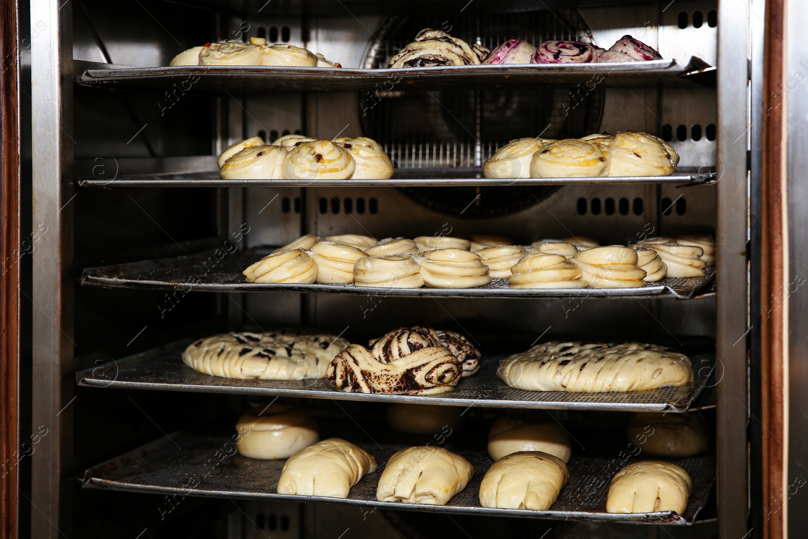 Photo of Oven with pastries in bakery workshop