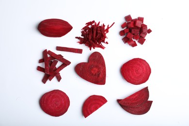 Photo of Composition with cut raw beets on white background, top view