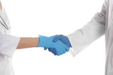 Doctors shaking hands on white background, closeup